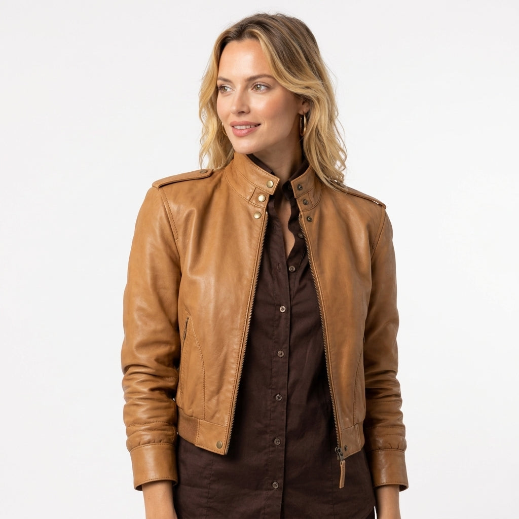 Women's tan leather jacket styled with a neutral shirt and black pants for a classic casual look
