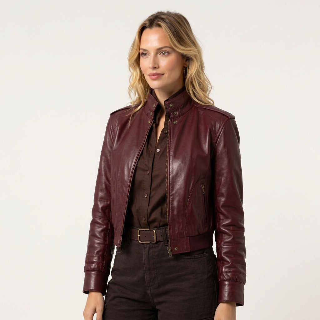 Women's maroon leather jacket styled with a dark shirt and black pants for a classic casual outfit