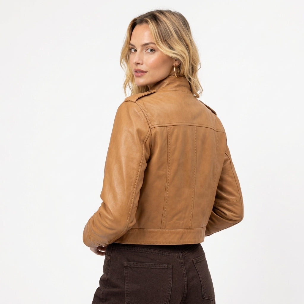Close-up of a tan leather jacket showing the collar buttons, leather texture, and front zipper details