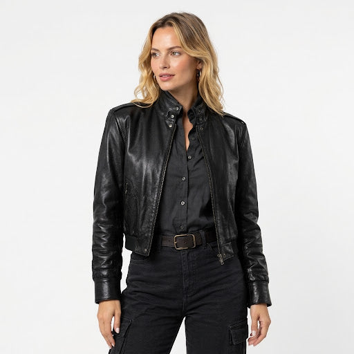 Women's black leather jacket styled with a dark shirt and black pants for a classic casual look