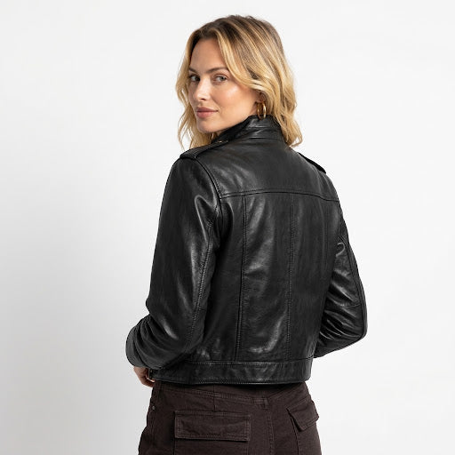 Close-up of a black women's leather jacket showing the collar buttons, smooth leather finish, and zipper details